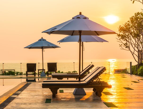 beautiful-umbrella-chair-around-swimming-pool-hotel-resort-min